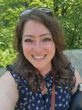 woman smiles while facing camera