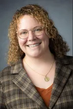 smiling white woman with curly hair